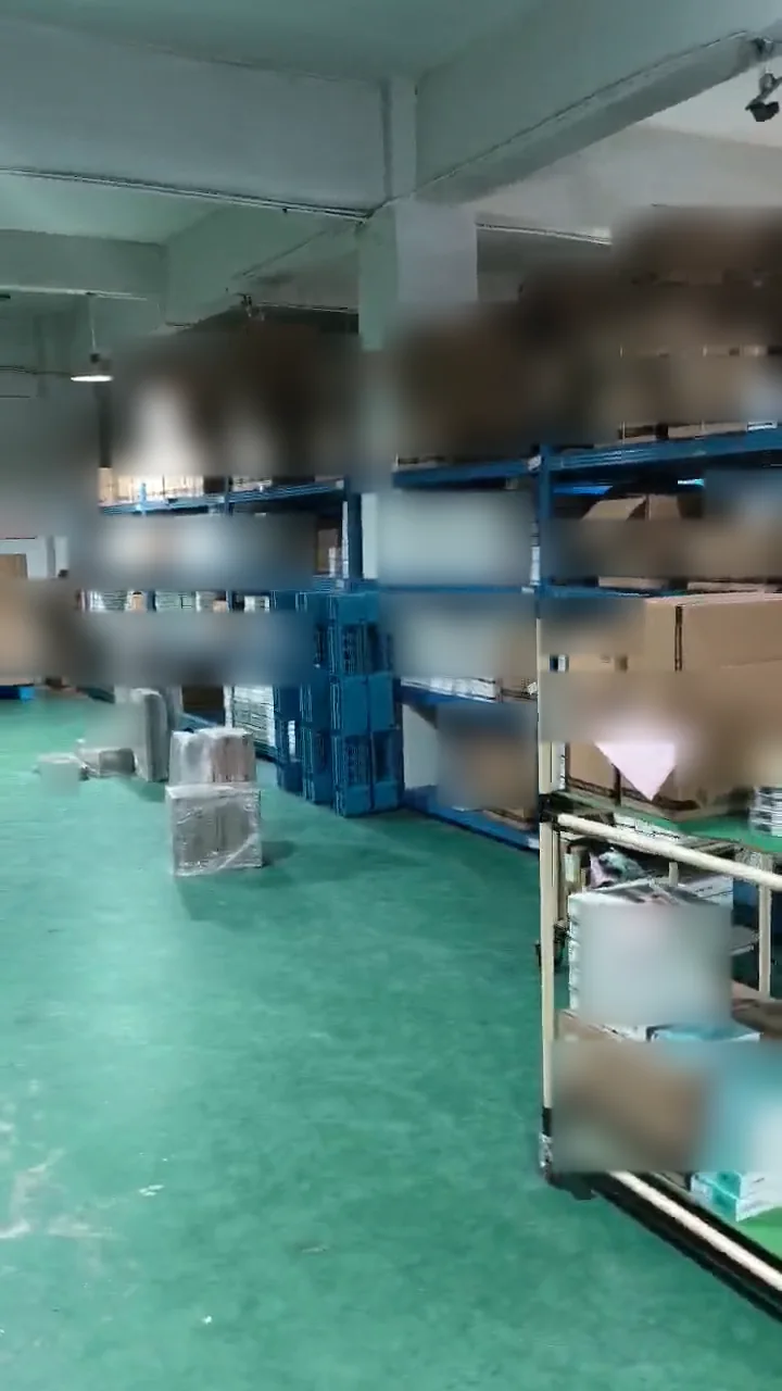 Green warehouse floor beside shelving, pallets and a trolley